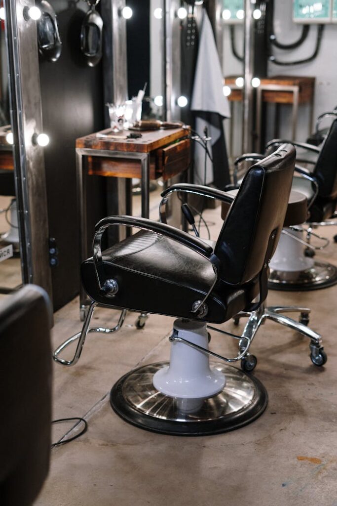 The Art of Drawing Readers In: Your attractive post title goes here Empty barber shop with sleek chairs and illuminated mirrors.
